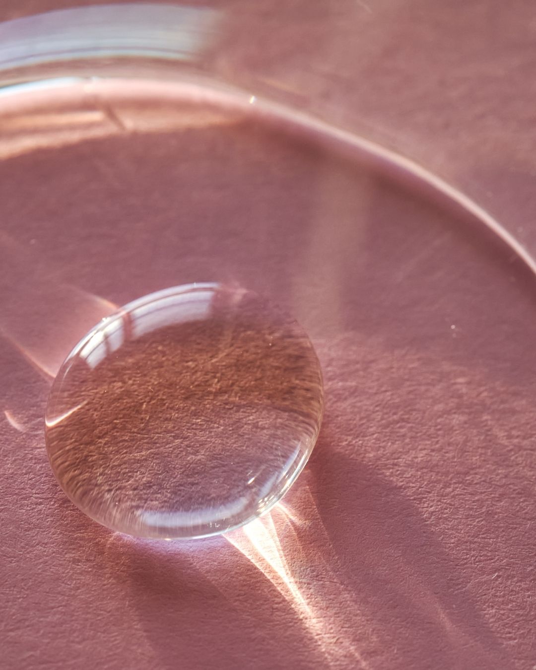 Hyaluronic acid droplet on pink background