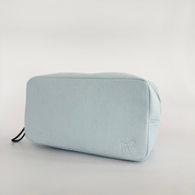 A soft‑touch corduroy bag Light blue textured pouch with a brand logo on a light gray background
