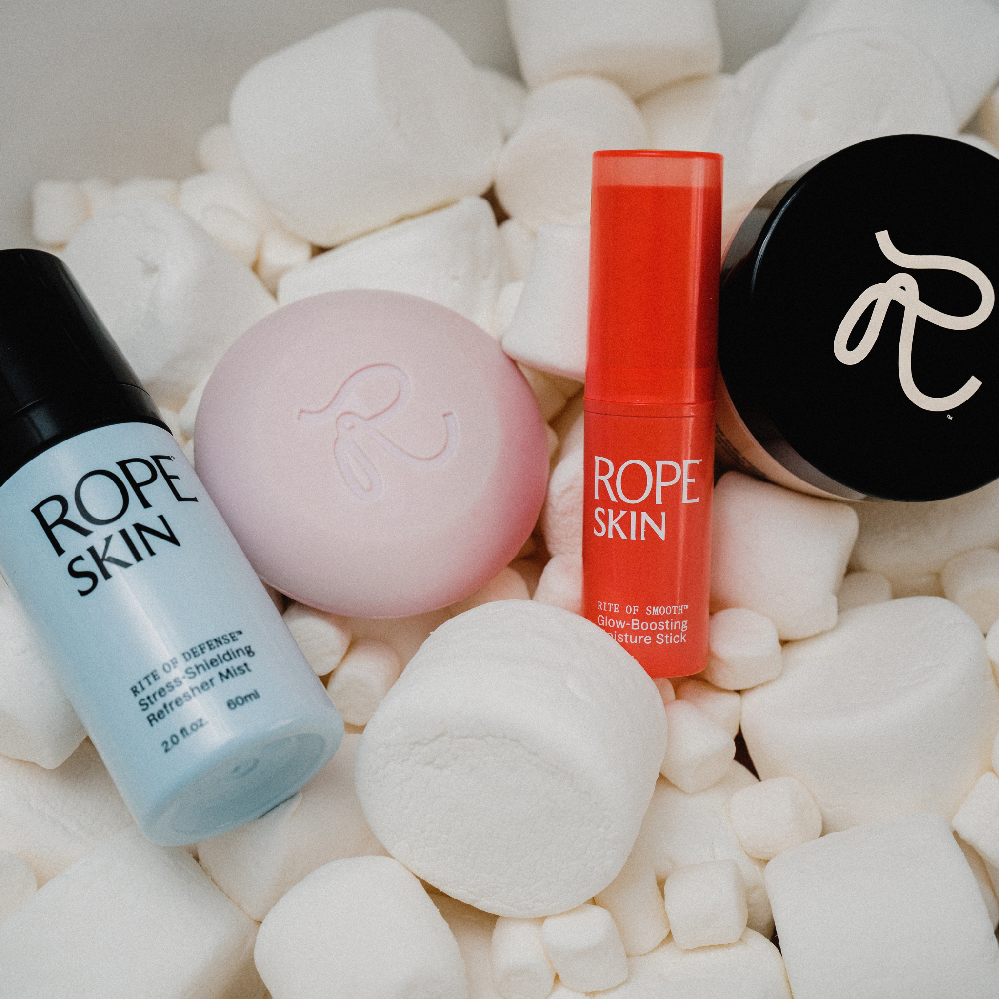 Skincare products from Rope Skin on a white background with marshmallows